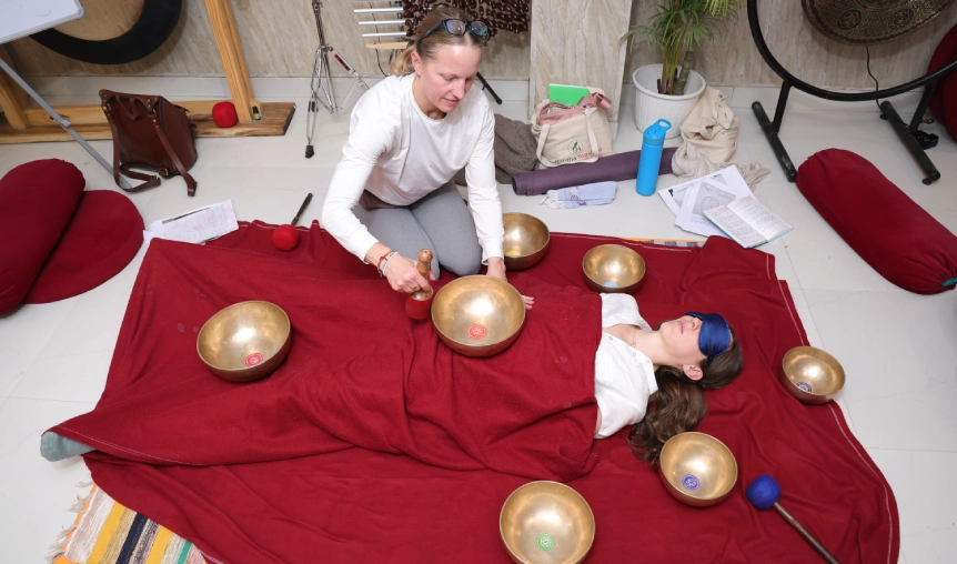 Group sound healing class with singing bowls and gong at Haritha International Sound Healing School Rishikesh