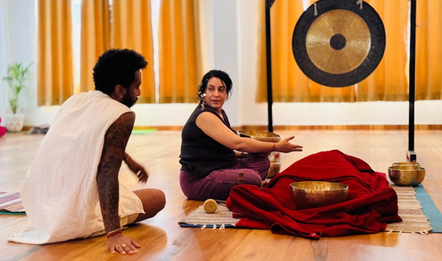 Himalayan singing bowls and mallets arranged on traditional rug